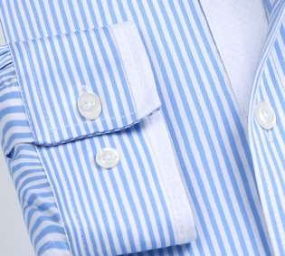 A striped shirt cuff with contrast piping